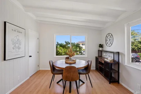 a dining room with furniture and window