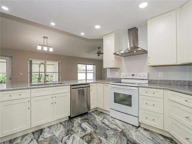 a kitchen with stainless steel appliances granite countertop a sink and cabinets