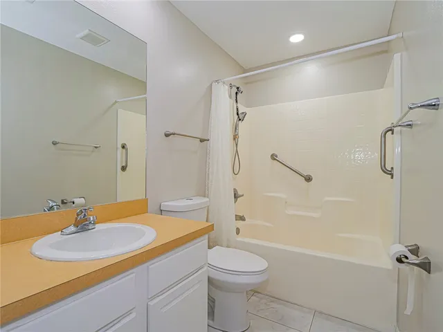 an empty room with a window and a ceiling fan