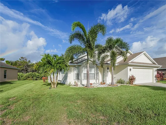 a view of house with yard and entertaining space