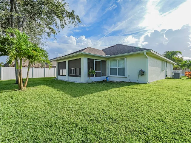 a front view of a house with a yard and street view