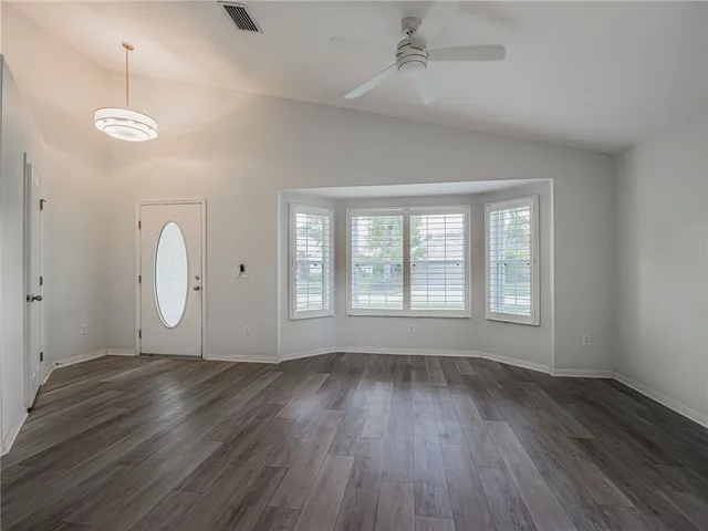 a view of a room with wooden floor and window