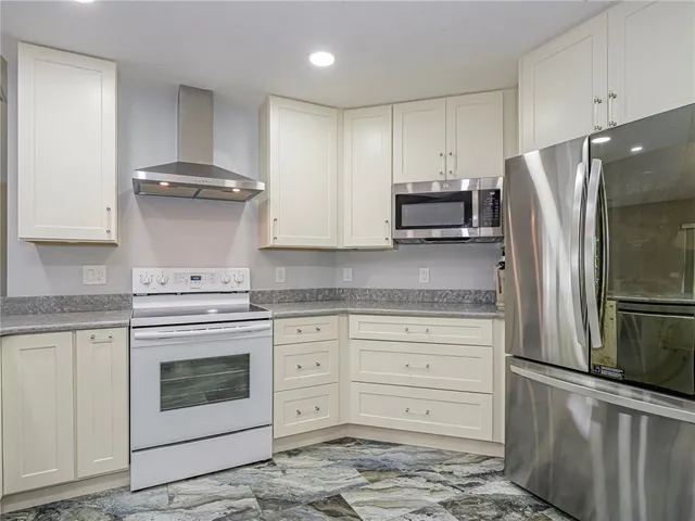 a kitchen with granite countertop cabinets and stainless steel appliances