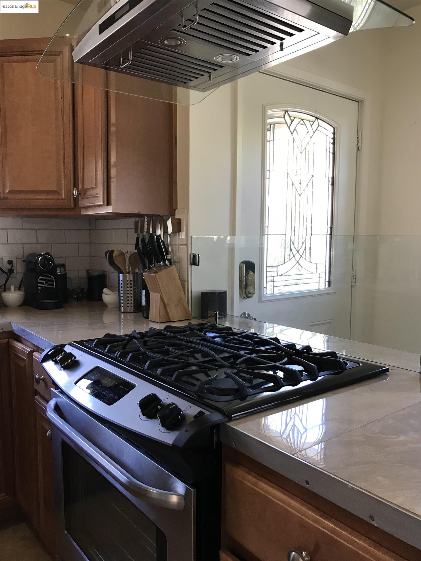 2408 Eighth Street Berkeley, CA 94710 - Photo 3 of 14 a kitchen with a stove and a white cabinets