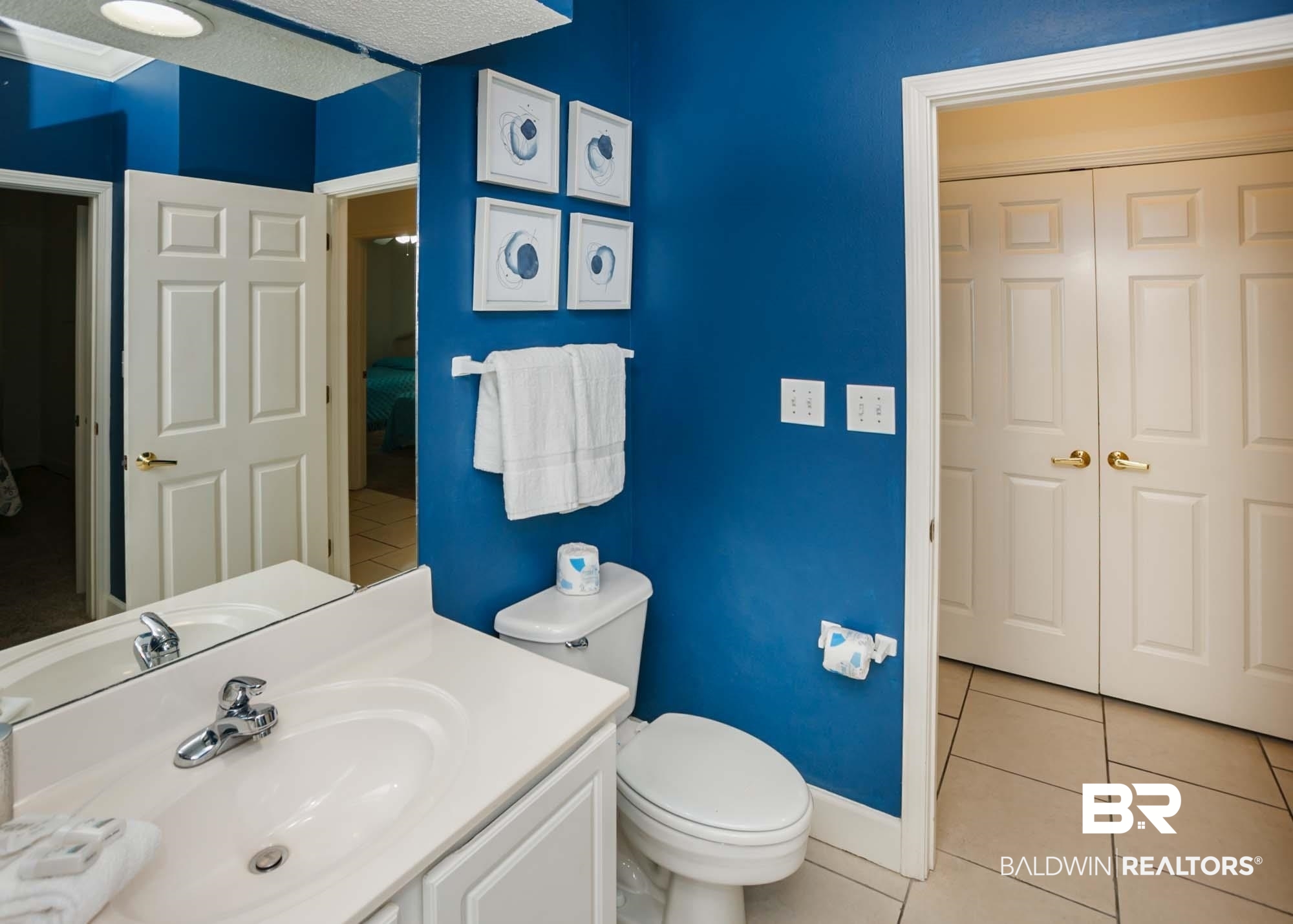 28910 Perdido Beach Boulevard, Unit 4B Orange Beach, AL 36561 - Photo 32 of 48 Ensuite bathroom featuring baseboards, toilet, vanity, ensuite bath, and tile patterned flooring