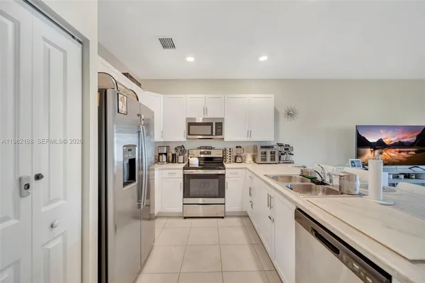 a white refrigerator freezer sitting in a kitchen