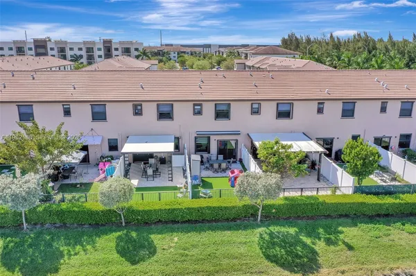 a aerial view of a house with a yard and potted plants