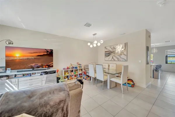 a living room with furniture a rug and gym equipment