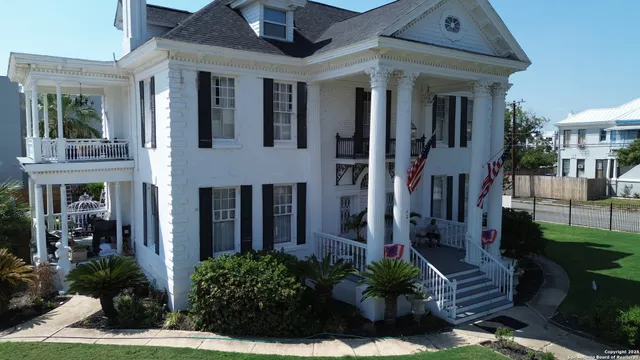 a front view of a house with outdoor seating