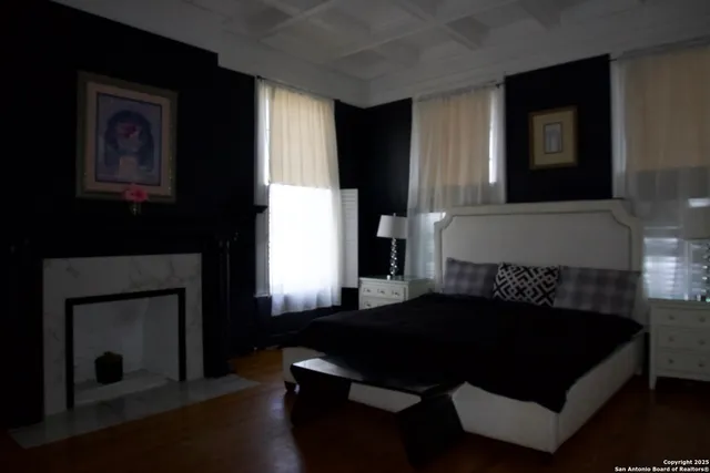 a bedroom with a bed and a fireplace