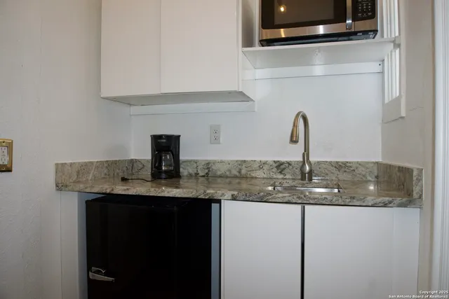 a kitchen with cabinets and stainless steel appliances