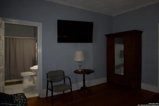 a bathroom with a toilet a sink and mirror