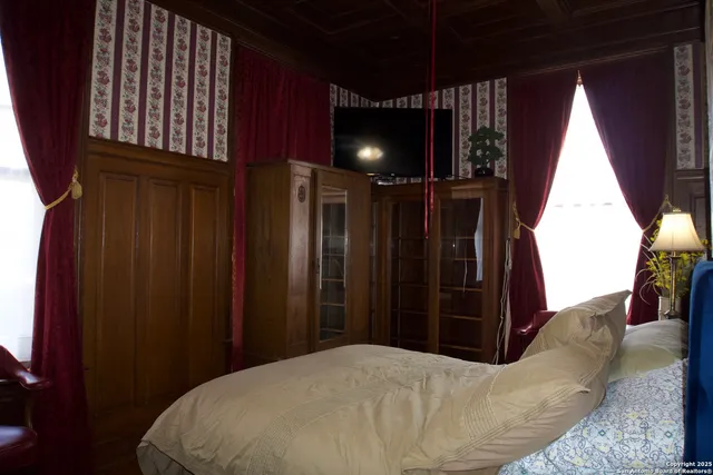 a bedroom with a bed and a mirror