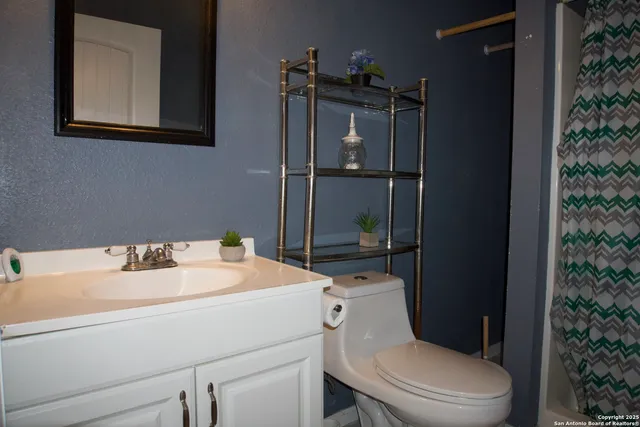 a bathroom with a toilet sink and shower