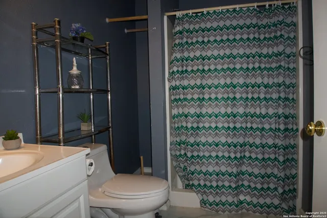 a bathroom with a toilet and a shower