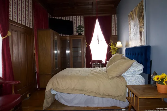 a bed sitting in a bedroom next to a window