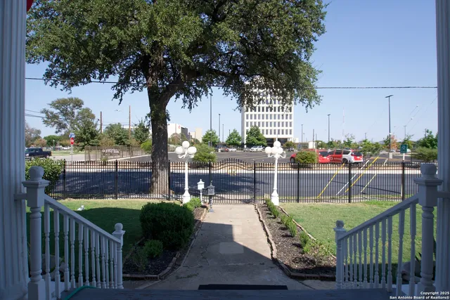 a patio with glass top table and chairs