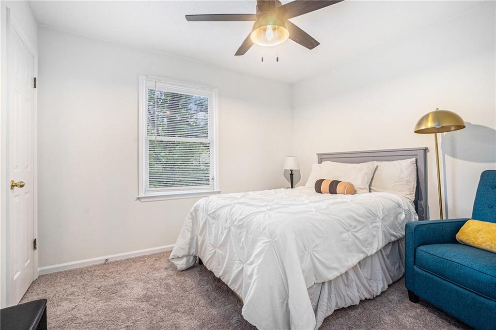 1883 Suwanee Terrace Northwest Suwanee, GA 30024 - Photo 11 of 25 a bedroom with a bed couch and window