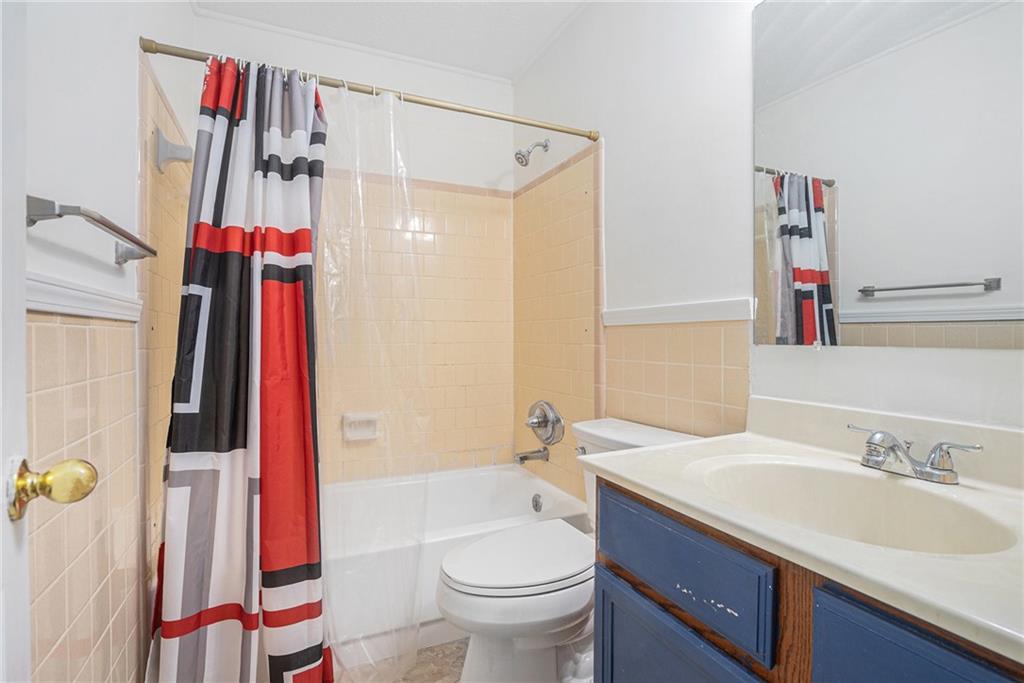 1883 Suwanee Terrace Northwest Suwanee, GA 30024 - Photo 13 of 25 a bathroom with a sink toilet and shower