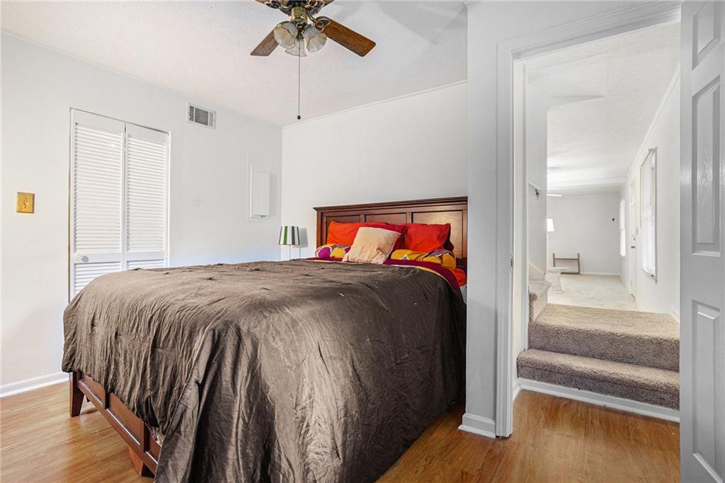 1883 Suwanee Terrace Northwest Suwanee, GA 30024 - Photo 17 of 25 a bedroom with a bed and a chandelier