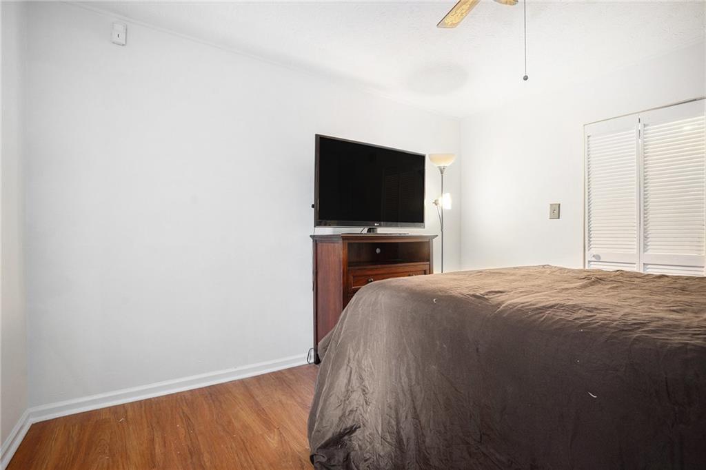 1883 Suwanee Terrace Northwest Suwanee, GA 30024 - Photo 18 of 25 a bedroom with a bed and a flat screen tv