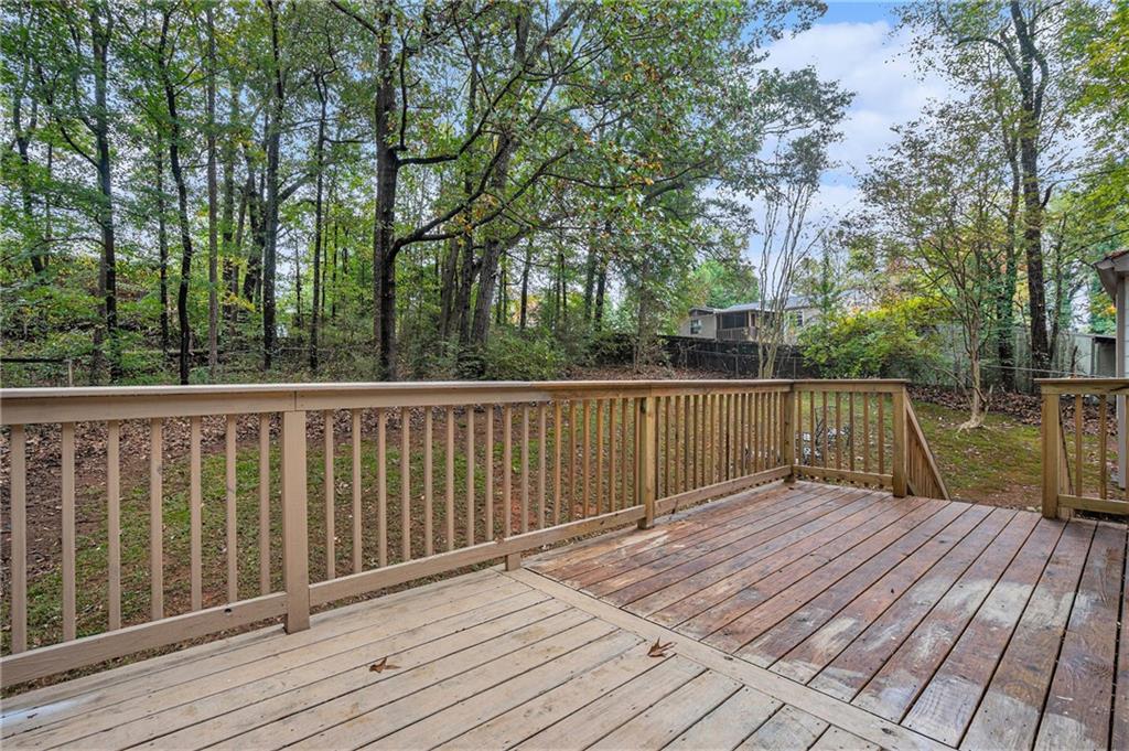 1883 Suwanee Terrace Northwest Suwanee, GA 30024 - Photo 19 of 25 a balcony with wooden floor and fence