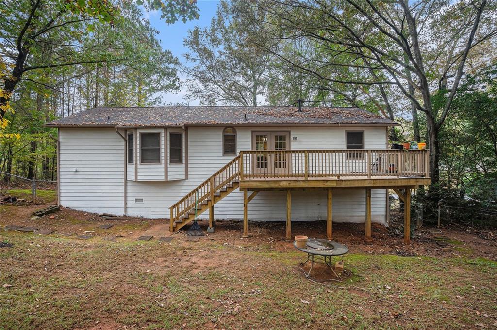 1883 Suwanee Terrace Northwest Suwanee, GA 30024 - Photo 20 of 25 a view of a house with a backyard and chairs