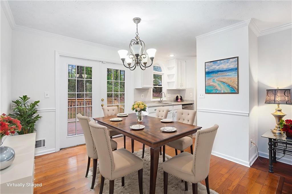 1883 Suwanee Terrace Northwest Suwanee, GA 30024 - Photo 3 of 25 a view of a dining room with furniture window and wooden floor