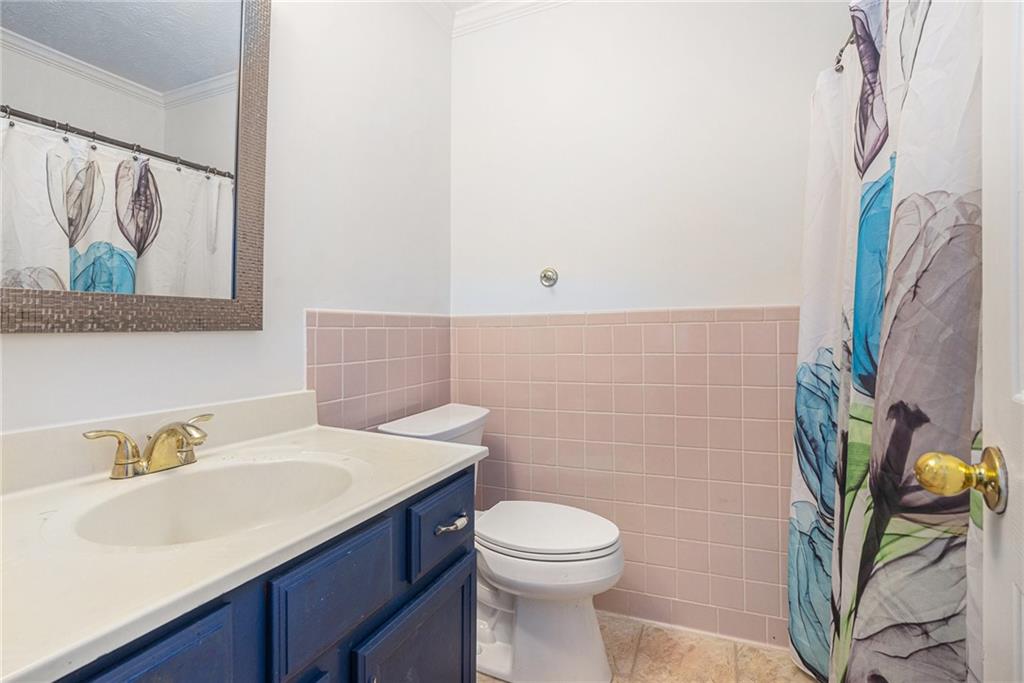 1883 Suwanee Terrace Northwest Suwanee, GA 30024 - Photo 8 of 25 a bathroom with a sink mirror vanity and toilet