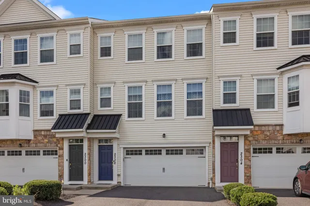a front view of residential houses with stairs