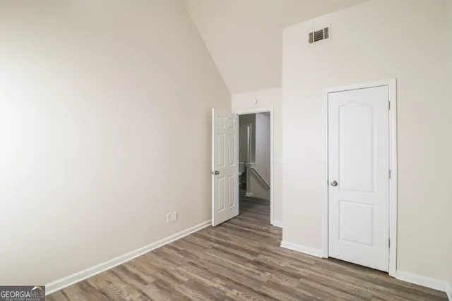 a view of a room with wooden floor and a hallway