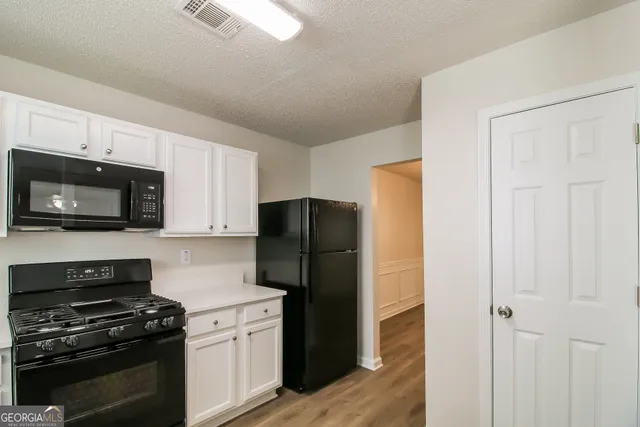 a kitchen with a refrigerator stove and microwave