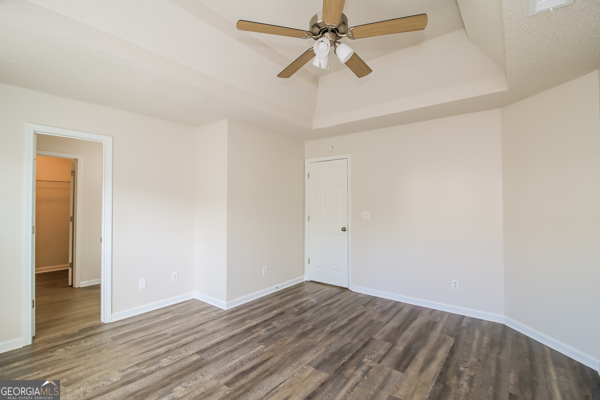 225 Colser Drive Covington, GA 30016 - Photo 9 of 17 a view of a room with wooden floor and ceiling fan