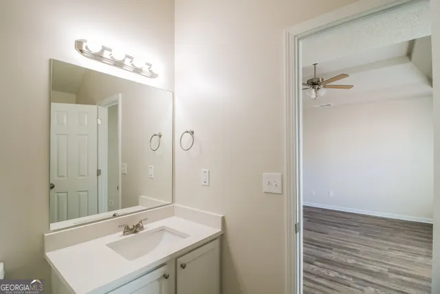 a bathroom with a sink shower and a mirror