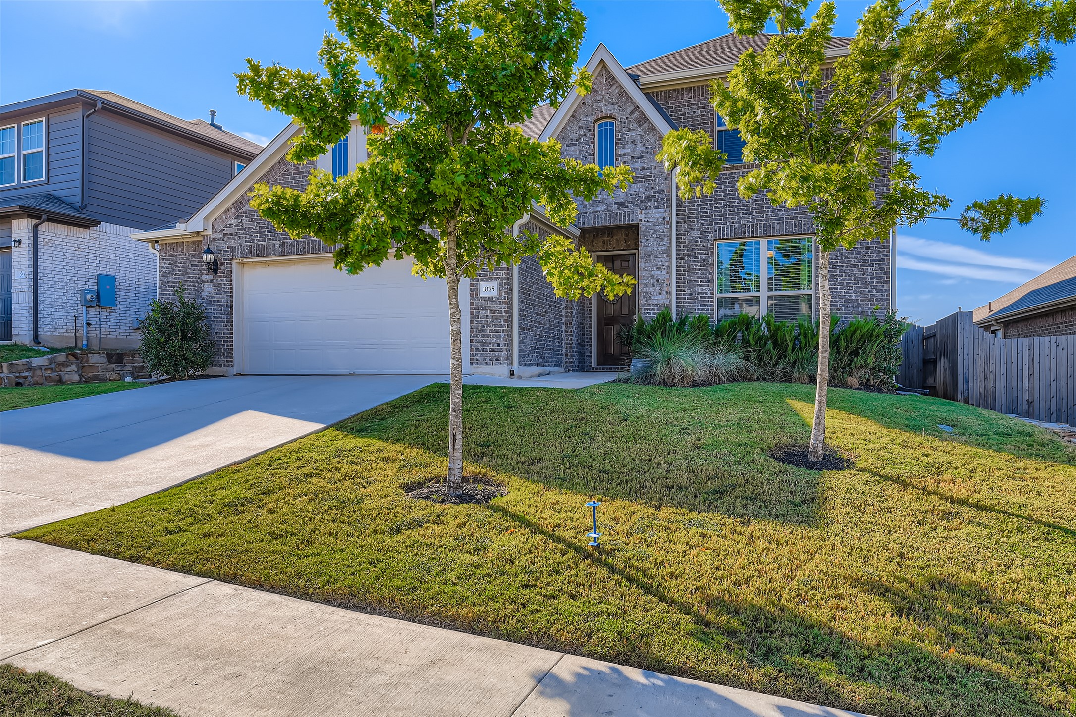 1075 Cherrystone Loop Buda, TX 78610 - Photo 1 of 1 Traditional-style home featuring concrete driveway and brick siding