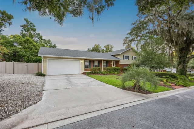 a front view of house with yard and green space