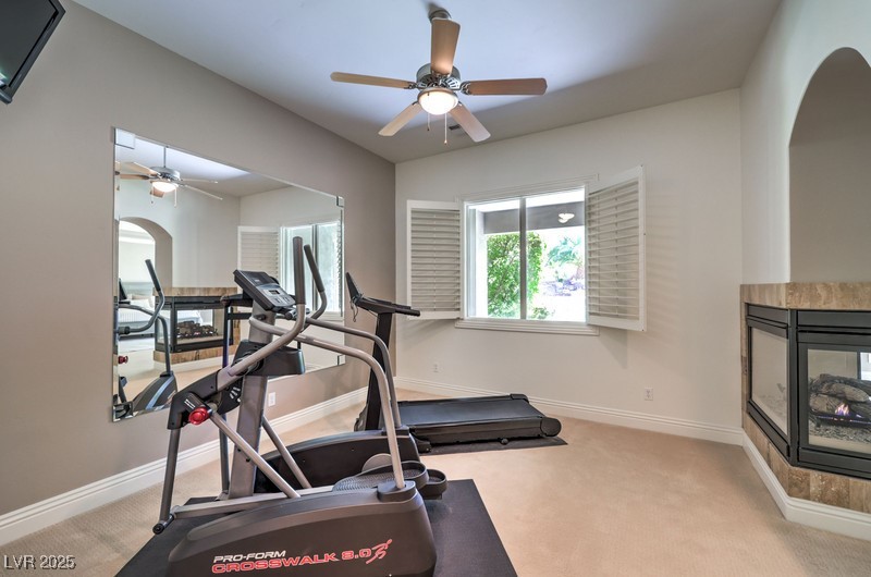 9135 Hickam Avenue Las Vegas, NV 89129 - Photo 28 of 75 Exercise area featuring arched walkways, ceiling fan, and carpet flooring