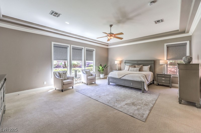9135 Hickam Avenue Las Vegas, NV 89129 - Photo 29 of 75 Bedroom featuring light carpet, ornamental molding, a raised ceiling, and ceiling fan