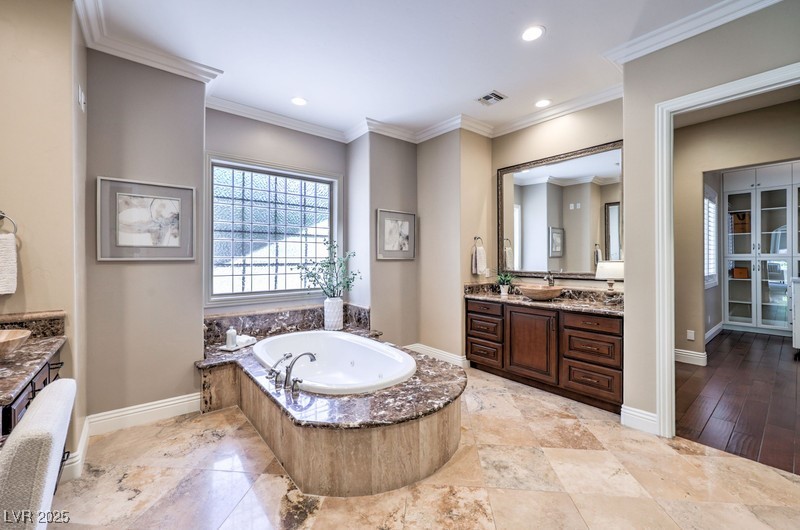 9135 Hickam Avenue Las Vegas, NV 89129 - Photo 32 of 75 Full bath with vanity, a garden tub, crown molding, and recessed lighting
