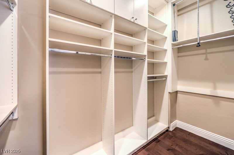 9135 Hickam Avenue Las Vegas, NV 89129 - Photo 35 of 75 Walk in closet featuring dark wood-type flooring