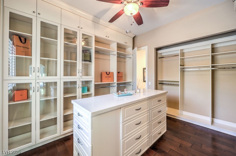 9135 Hickam Avenue Las Vegas, NV 89129 - Photo 36 of 75 Spacious closet with a ceiling fan and dark wood finished floors