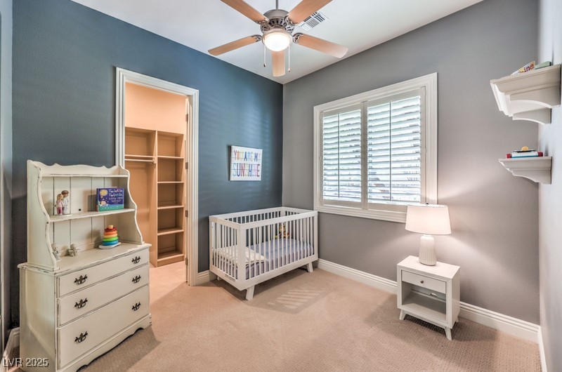 9135 Hickam Avenue Las Vegas, NV 89129 - Photo 44 of 75 Bedroom with light carpet, a crib, and a spacious closet