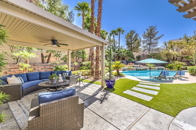 9135 Hickam Avenue Las Vegas, NV 89129 - Photo 49 of 75 View of patio with an outdoor living space, ceiling fan, and an outdoor pool