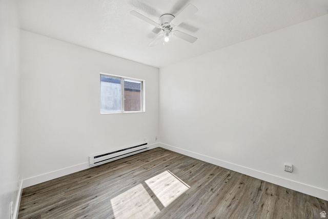 283 West 600 North, Unit 2 Logan, UT 84321 - Photo 17 of 36 Room featuring wood-finish flooring, white baseboards, and a window with white trim