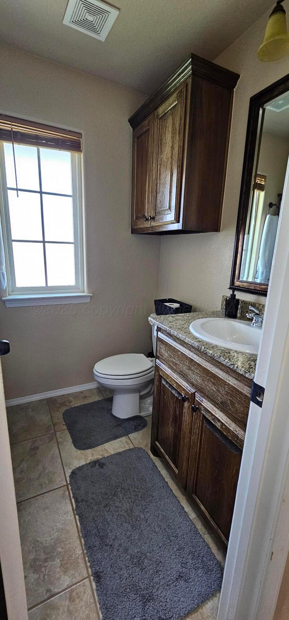 1819 Wagon Trail Road Dalhart, TX 79022 - Photo 12 of 15 a bathroom with a sink a stove and cabinets