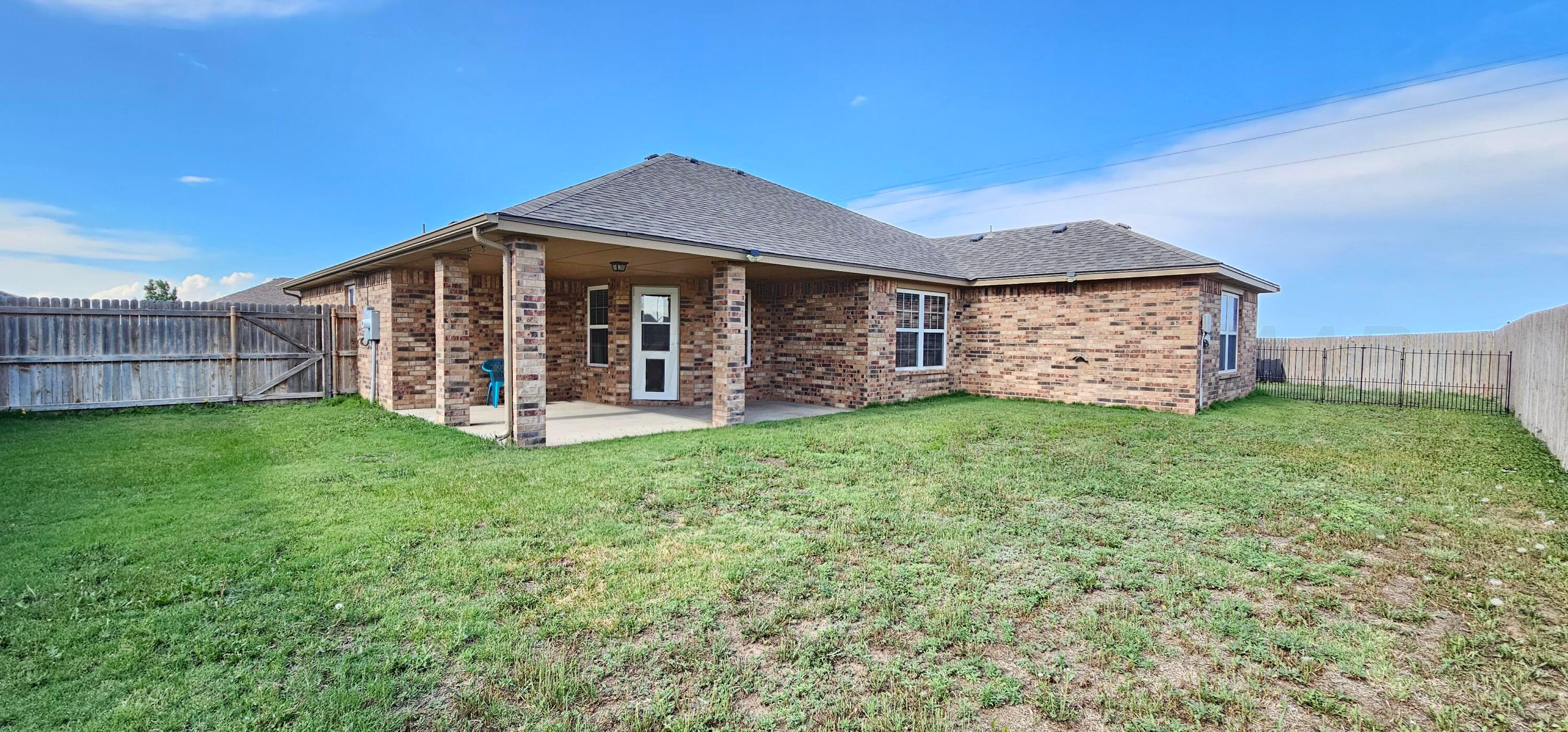 1819 Wagon Trail Road Dalhart, TX 79022 - Photo 14 of 15 a view of a house with a yard