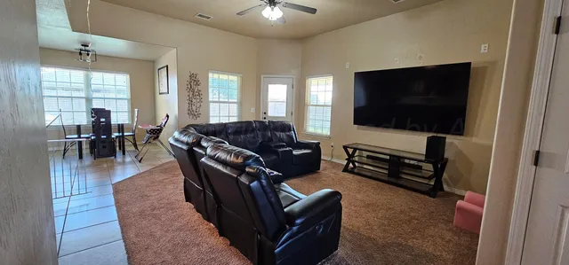 a living room with furniture and a flat screen tv