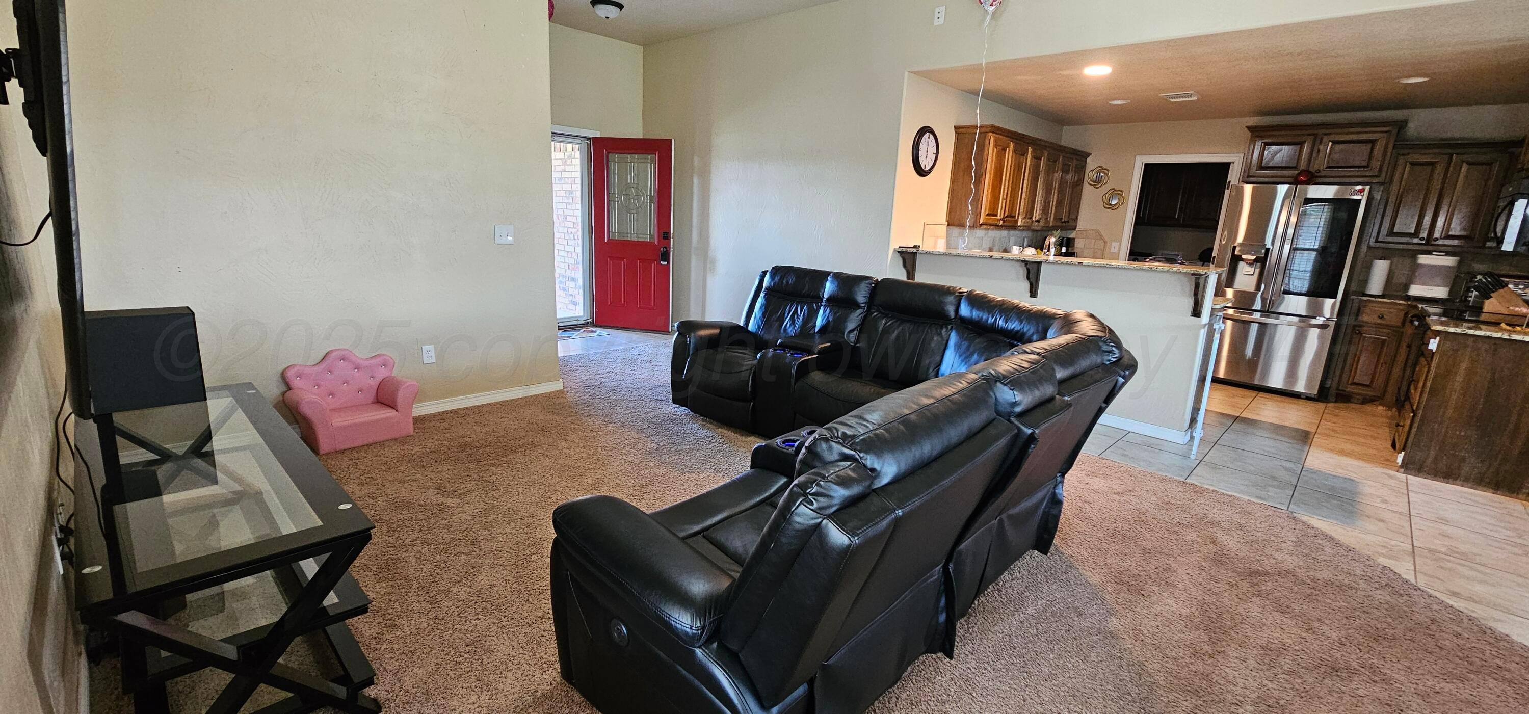 1819 Wagon Trail Road Dalhart, TX 79022 - Photo 6 of 15 a living room with furniture and a flat screen tv