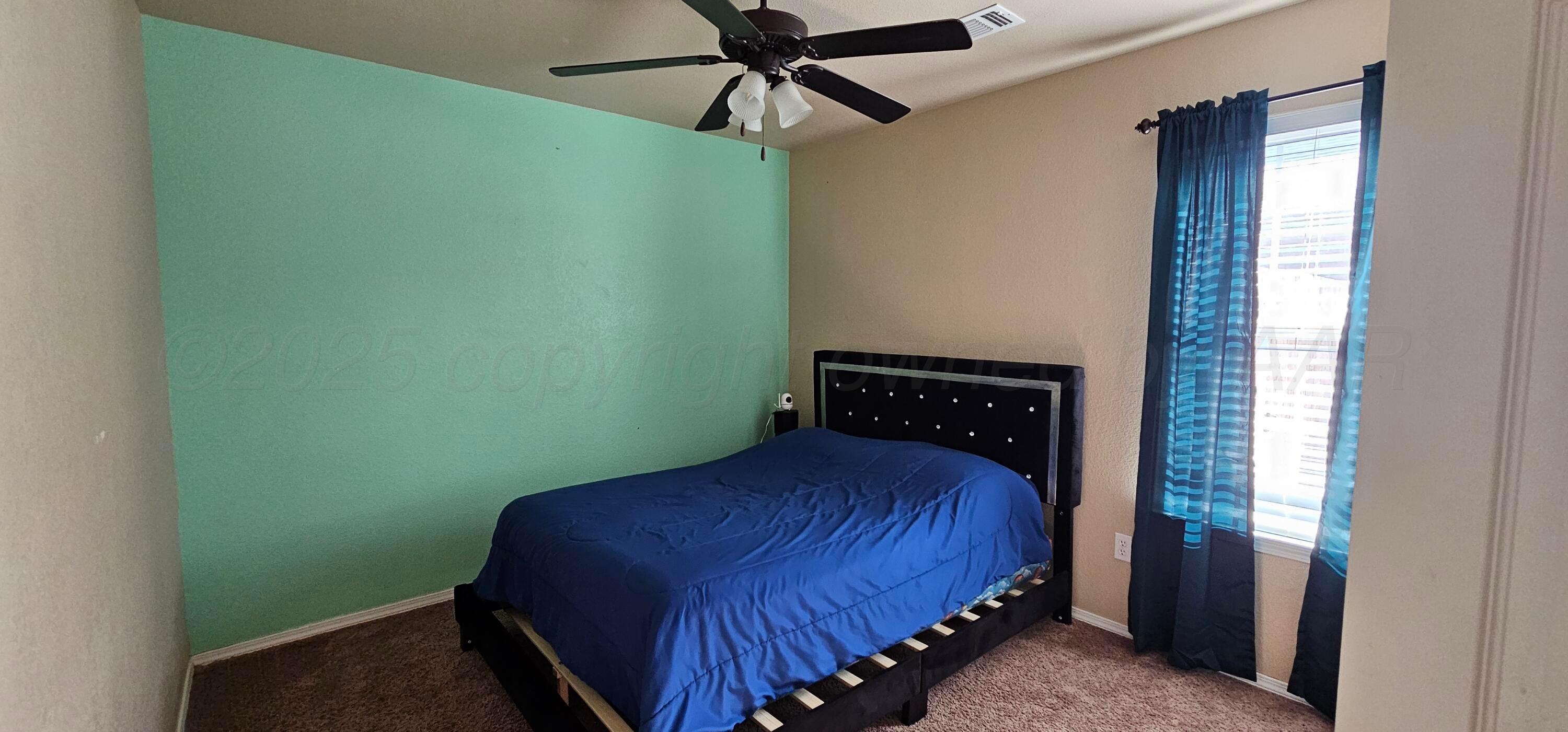 1819 Wagon Trail Road Dalhart, TX 79022 - Photo 9 of 15 a bedroom with a bed and a window