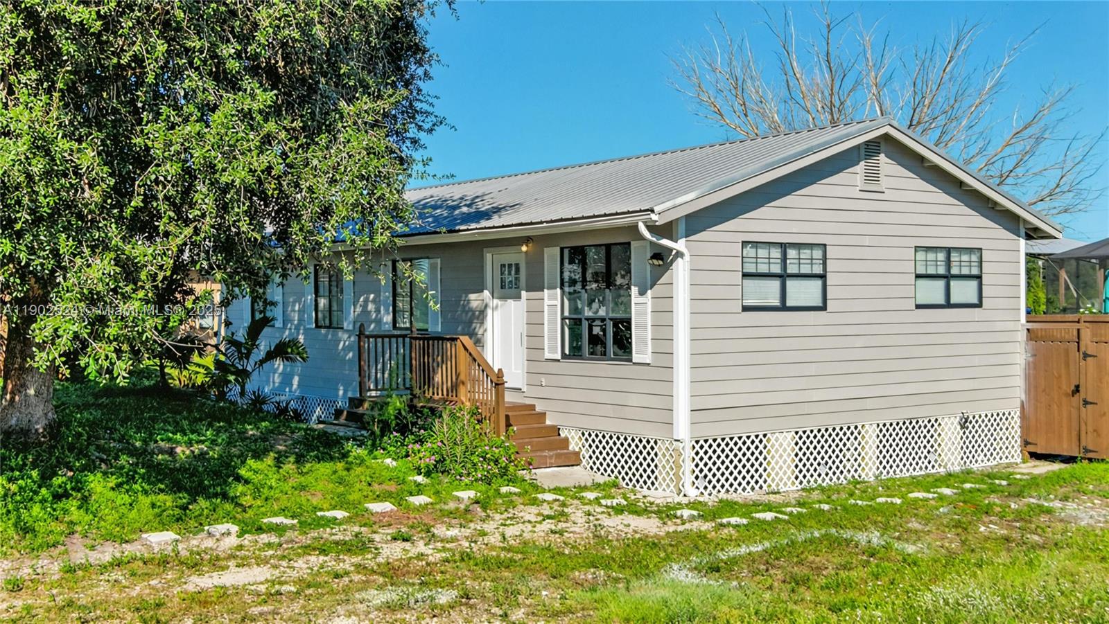 3216 22nd Street Southwest Lehigh Acres, FL 33976 - Photo 1 of 28 a view of a house with a yard
